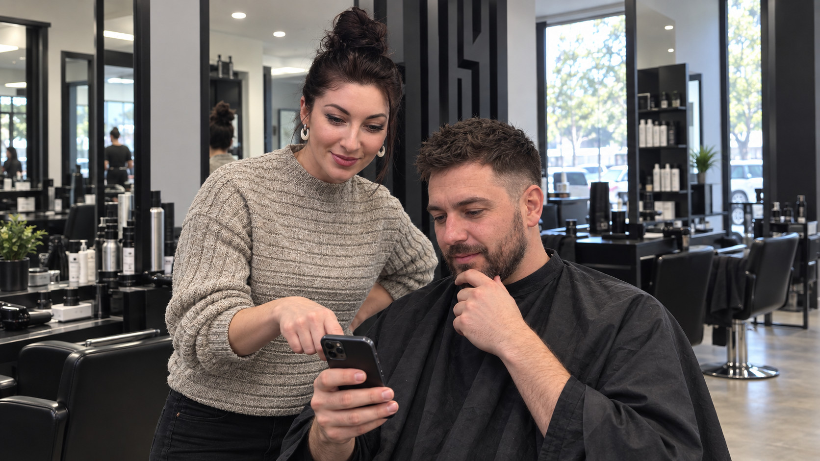 Barberka omawia z klientem zdjęcie wybranej fryzury